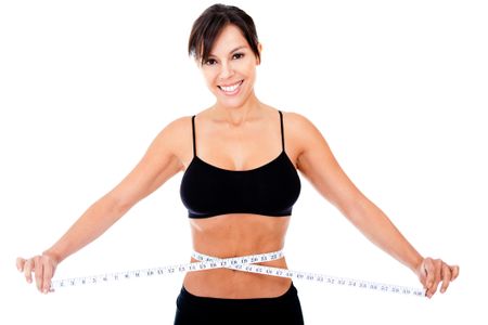 Woman loosing weight measuring her waist - isolated over a white background