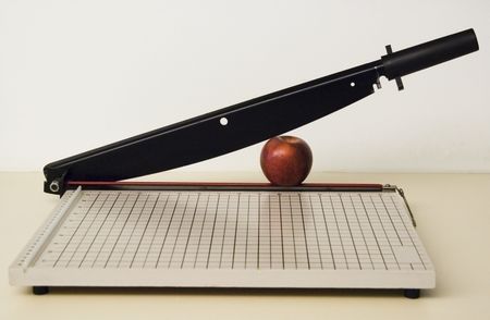 Apple in a paper cutter