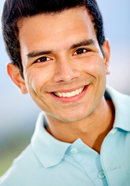 Portrait of a casual man smiling outdoors