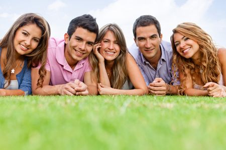 Group of people lying outdoors and smiling