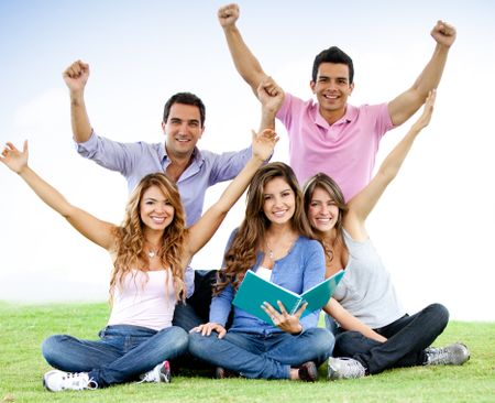 Excited group of students with arms up - outdoors