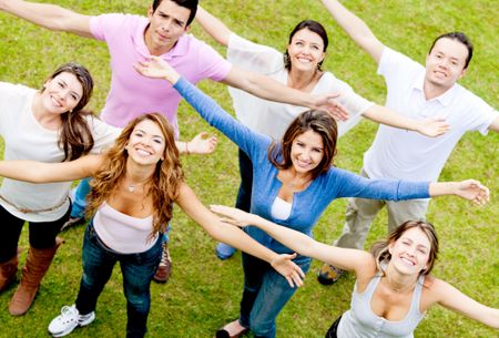 Group of people with arms open enjoying outdoors