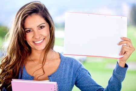 Female student holding a piece of paper to write something