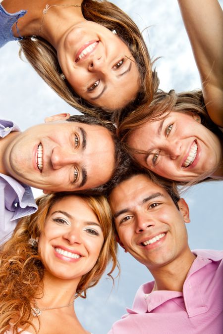 Young people in a group hug and smiling