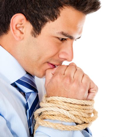 Tortured businessman holding his hands tied with a rope - isolated over white
