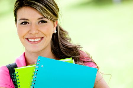 Girl studying and holding notebooks - education portrait