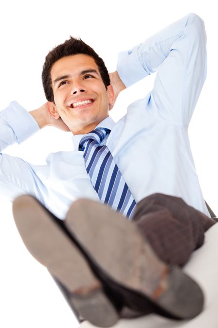 Businessman relaxing with feet on the desk - isolated over a white background