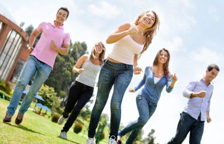 Happy group of friends running outdoors having fun