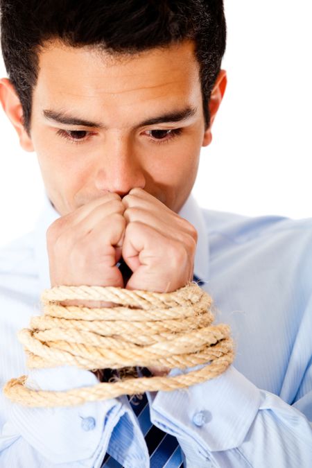Businessman with hands tied  using a rope - isolated over a white backround