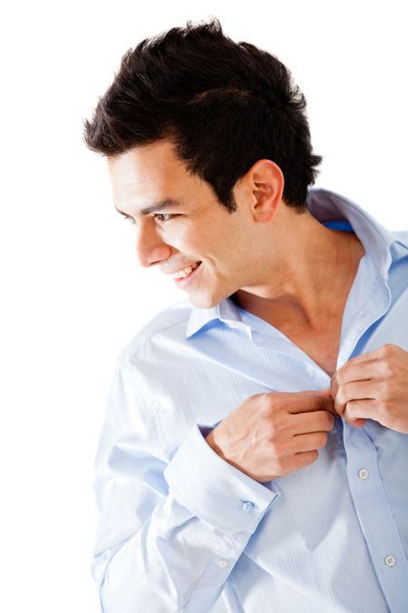 Man getting dressed buttoning his shirt - isolated over a white background
