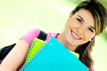 education-portrait-friendly-woman-holding-notebooks-96499568 Education portrait of a friendly woman holding notebooks