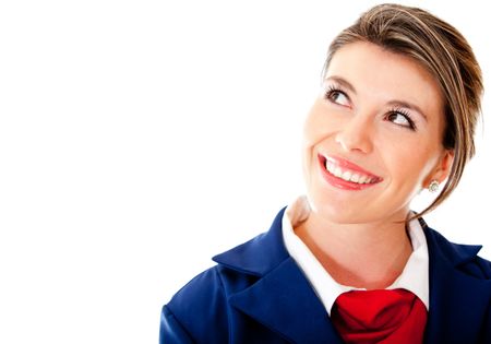 Pensive air hostess looking up - isolated over a white background