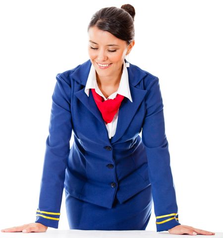 Air hostess leaning on a table - isolated over a white background