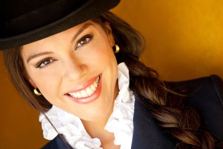 Beautiful horsewoman portrait wearing a hat and smiling