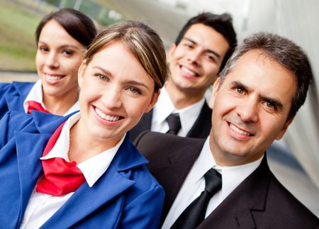 Portrait of a friendly group of pilots and air hostesses smiling