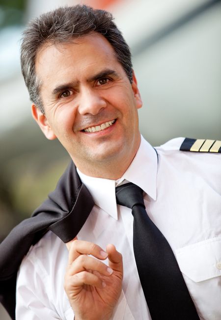 Portrait of a friendly pilot at the airport looking happy