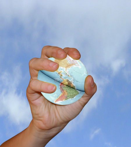 Hand catching an earth globe