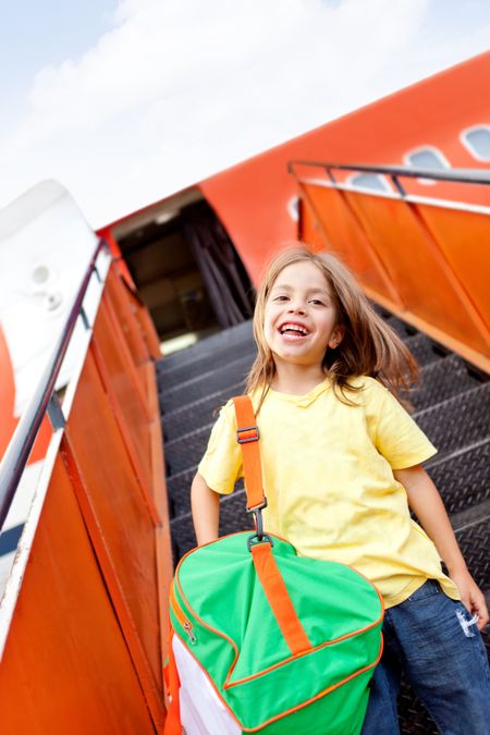 Happy boy going on holidays by airplane