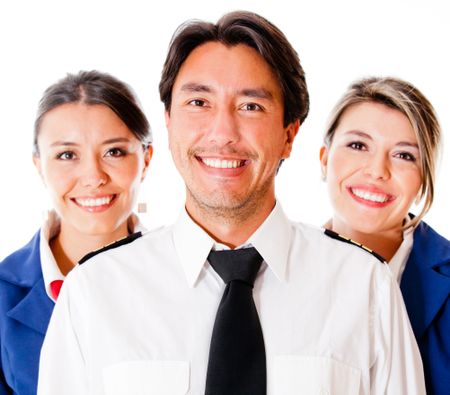 Pilot and flight attendants smiling Ã?Â¢?? isolated over a white background