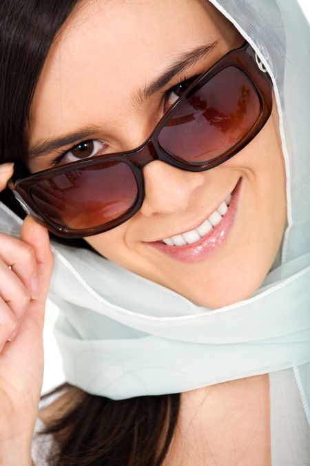 fashion or casual woman portrait wearing sunglasses giving a big smile - isolated over a white background