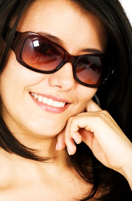 fashion or casual woman portrait wearing sunglasses giving a big smile - isolated over a white background