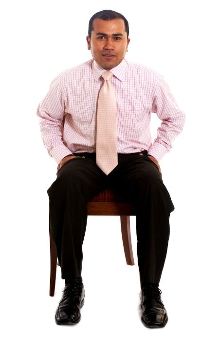 confident business man sitting on a chair isolated over a white background