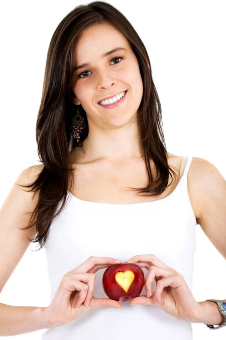 girl holding an apple with a heart shape isolated over a white background
