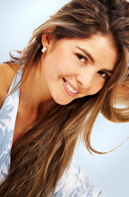 casual woman face smiling portrait over a light blue background