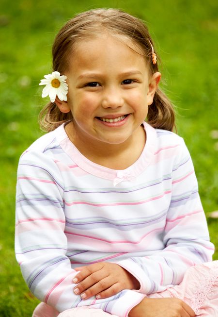 beautiful girl smiling with a flower on her ear