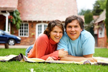 couple of young adults relaxing outdoors on the grass