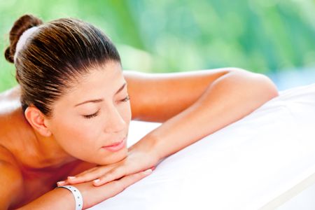 Relaxed woman lying down at an outdoors spa