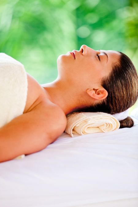 Beautiful woman lying down relaxing at a spa