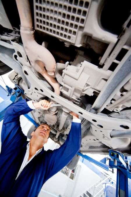 Mechanic fixing a car at the garage