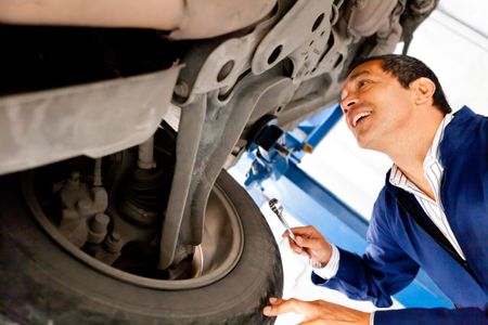 Mechanic working under a car at a repair shop