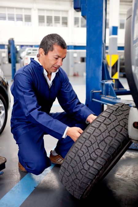 Mechanic fixing car wheel after a puncture