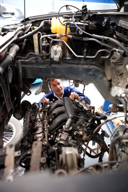 Mechanic working on the engine of a car