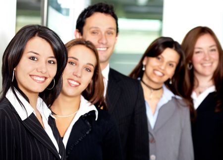 Business team in an office with a businesswoman leading