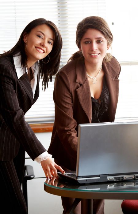 female business partners on an office computer at the office