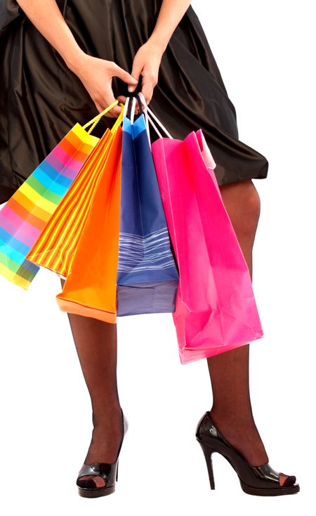 elegant woman wearing stilettos holding shopping bags isolated over a white background