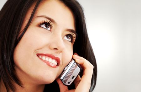 business woman on the phone smiling over a brown background