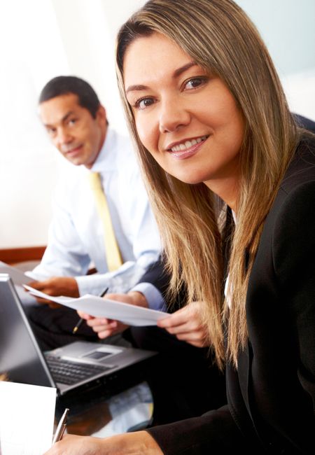 business man and woman in an office smiling