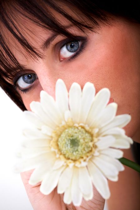 beautiful girl with a daisy flower by her face