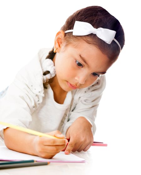 Girl coloring a book - isolated over a white background