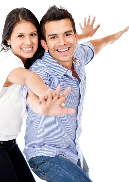 Happy couple with arms open - isolated over a white background