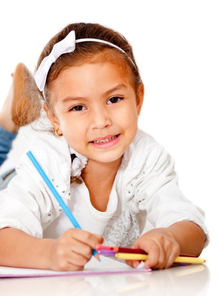 Beautiful girl coloring a book - isolated over a white background