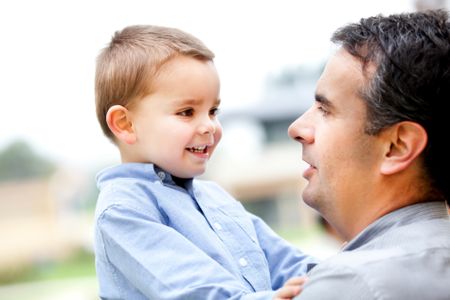 Portrait of a father holding his son Ã?Â¢?? outdoors