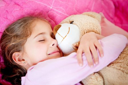 Cute little girl sleeping with a teddy bear