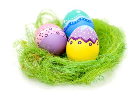 Easter eggs in a nest - isolated over a white background