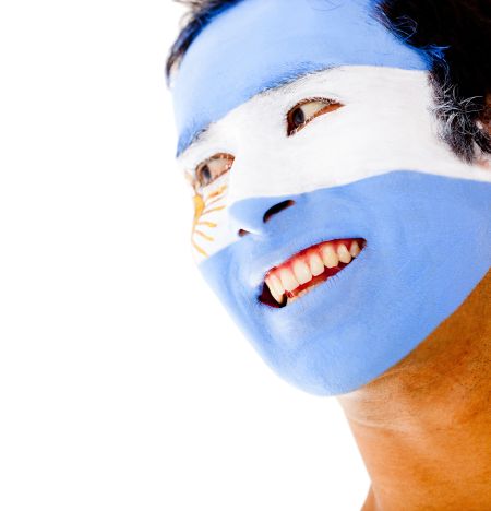 Portrait of a man with an Argentinean flag painted on his face