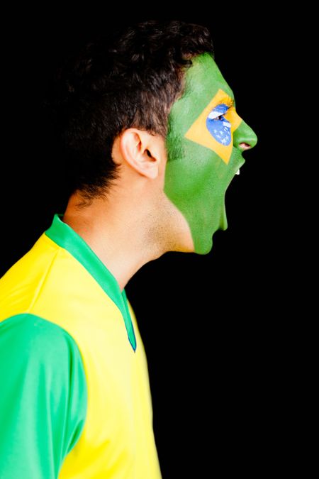 Excited Brazilian man shouting - isolated over  a black background